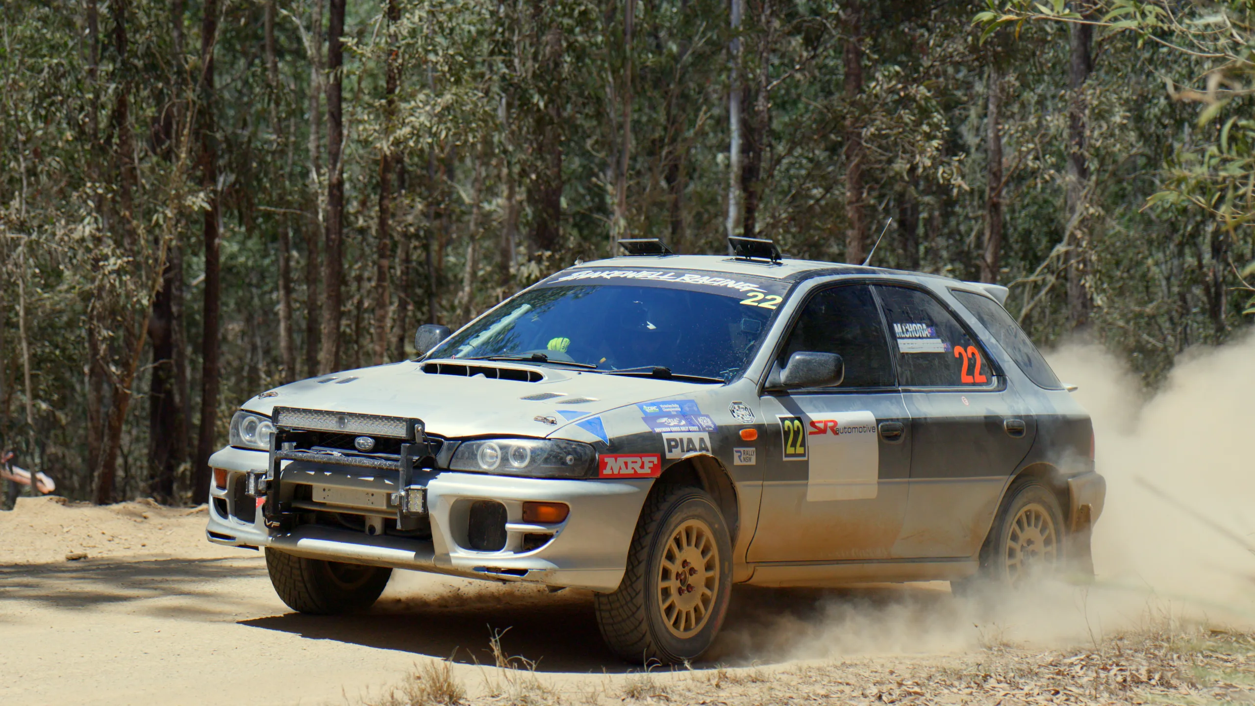 Car 22, the Shakewell Racing Subaru Impreza wagon, through a gravel corner in the forest at the Imbil Rally